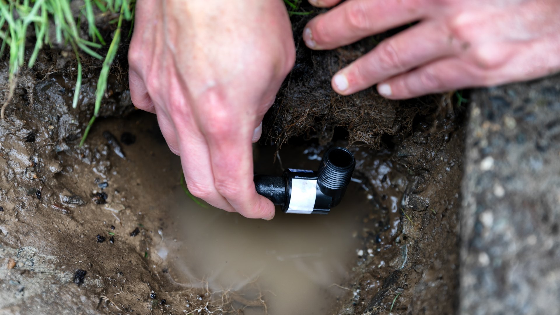 Irrigation tech repairing a faulty irrigation system in Sioux Falls, SD.