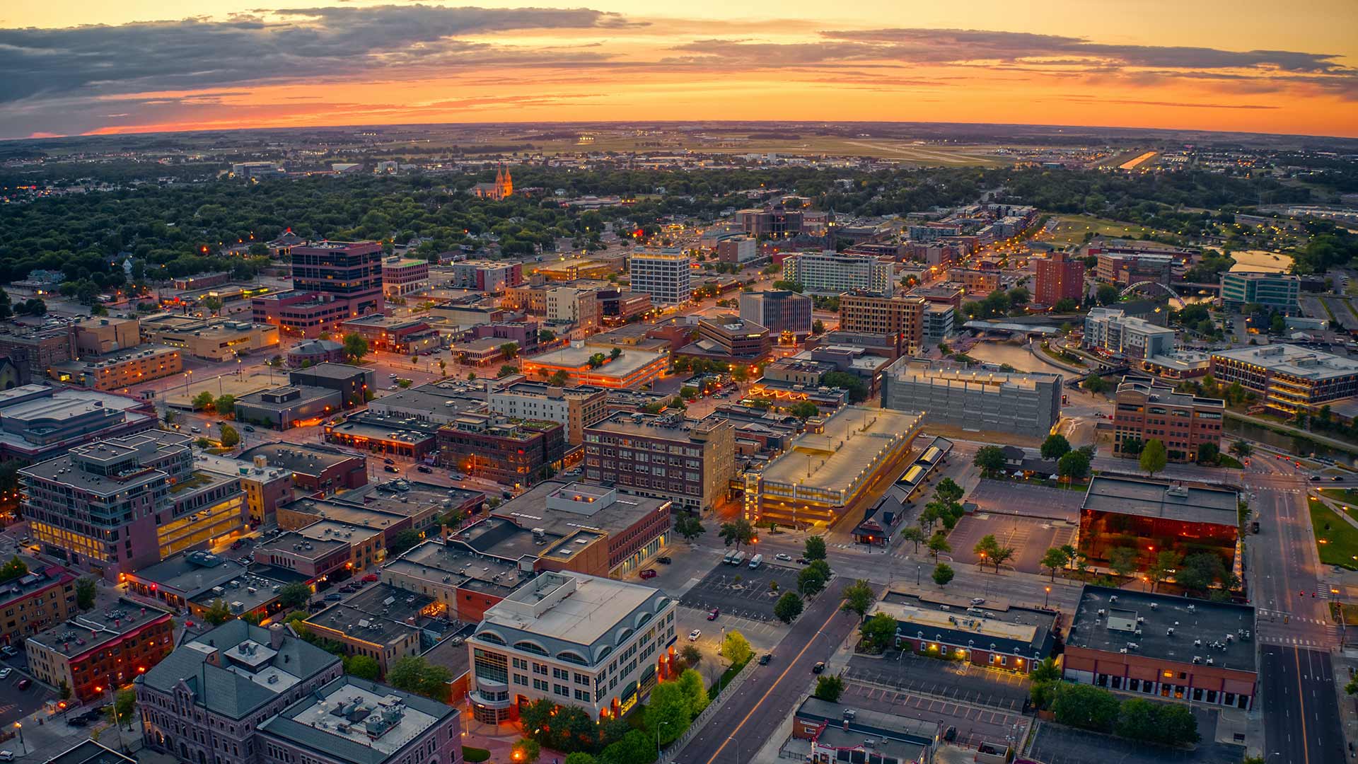 Aerial photo of Sioux Falls, SD at sunset with clouds.