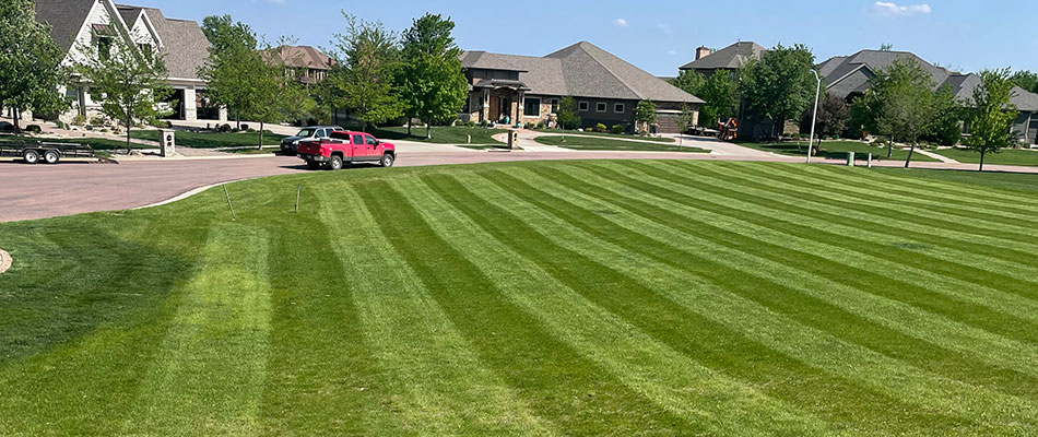 Large yard with green, thick grass and mowing lines near Harrisburg, SD.