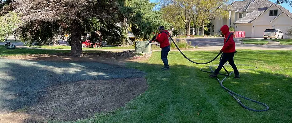 Lawn experts hydroseeding a bare spot in a yard near Sioux Falls, SD.