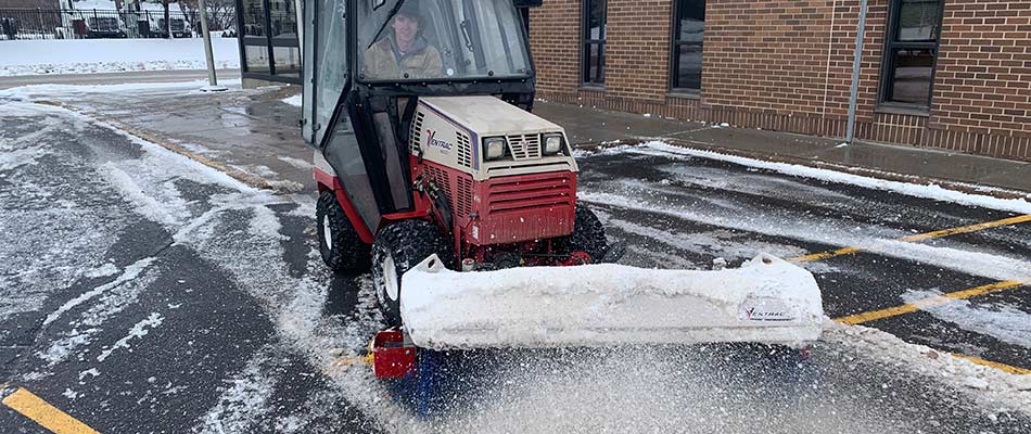 Ventrac deicing equipment clearing a commercial parking lot in Brandon, SD.